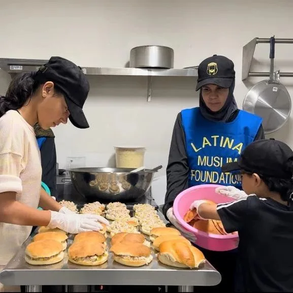 Volunteers preparing fresh sandwiches in the shelter kitchen