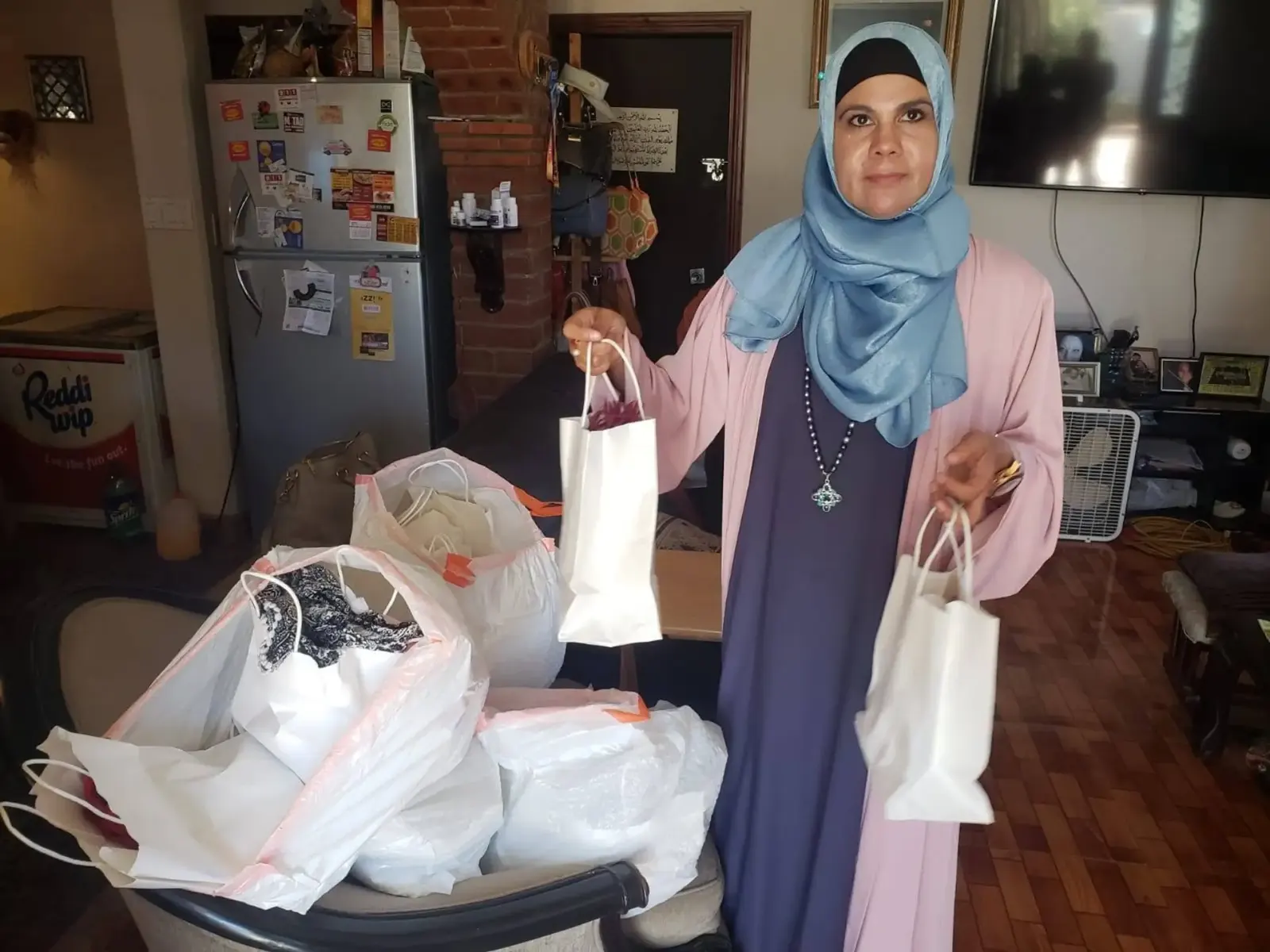Sister Sonia Garcia holding gift bags prepared for refugee families