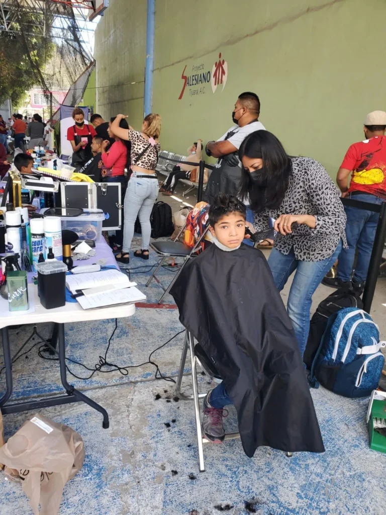 A child getting a free haircut at an outreach event