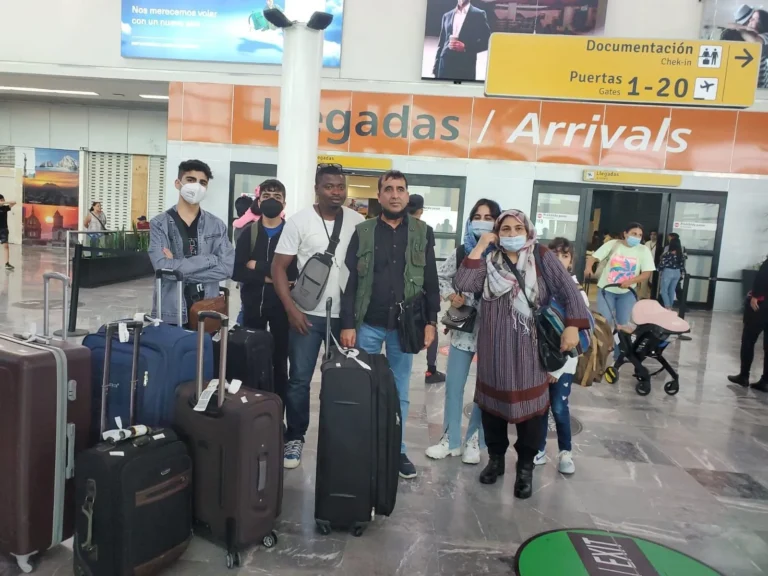 A family arriving with their luggage at the airport