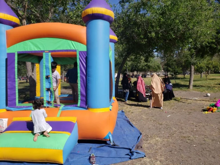 Children playing on a bouncy castle at a family day