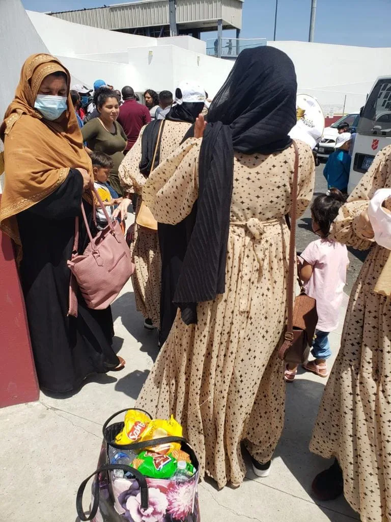 Muslim women and children gathered together outdoors