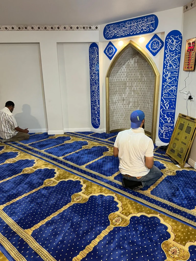 A man praying in the shelter's prayer hall