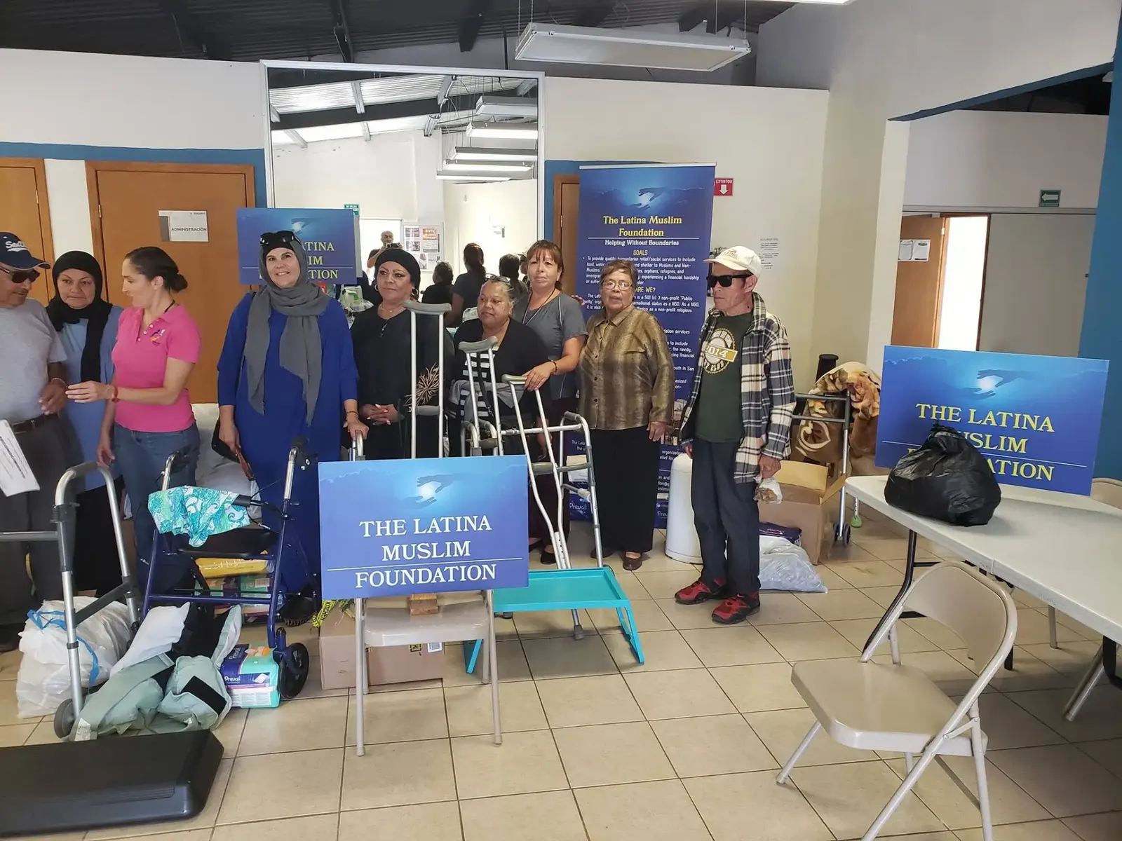Volunteers and community members at a Latina Muslim Foundation distribution of walkers, crutches and supplies
